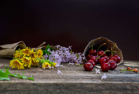 Cherry and flowers on a wooden craft tableの写真素材
