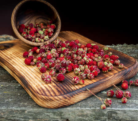 Sweet forest strawberries on a wooden backgroundの写真素材