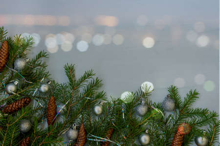 Christmas tree branches with cones and bokeh effect.の写真素材