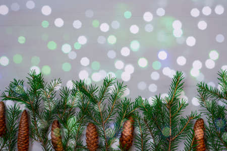 Christmas balls, fir branches and cones through glass with hoarfrost