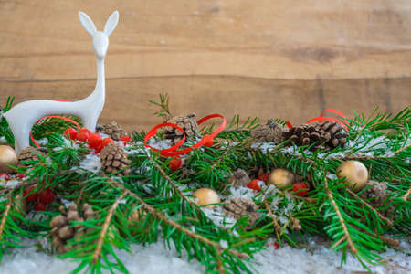 Christmas composition with fir branches, cones, berries and a toyの写真素材
