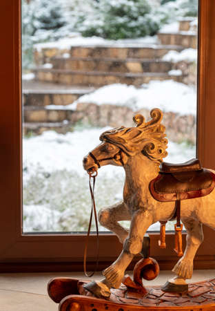 Retro rocking horse near the window on new years eveの写真素材