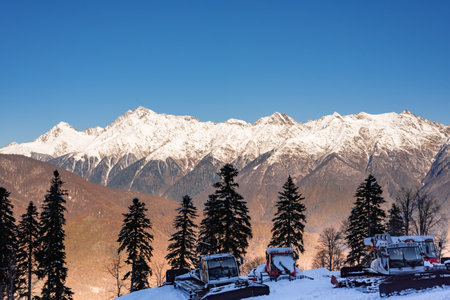 Ratraki for cleaning ski trails in the background of the mountains.