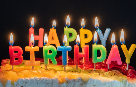 Burning candles in the form of letters Happy Birthdayの写真素材