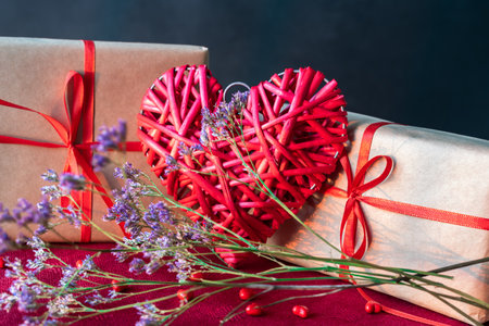 Red heart made of twigs and gift boxesの写真素材