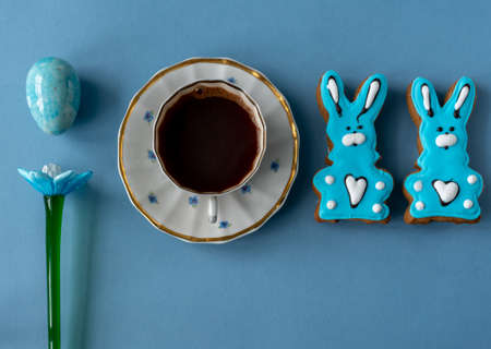 Blue easter bunny gingerbread cookie with a cup of coffee