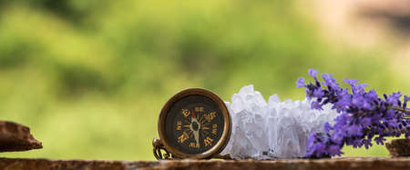 Mountain route planning - compass, binoculars, quartz crystals, slate and lavender flowersの写真素材