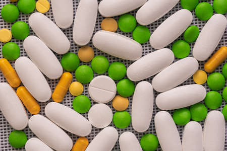 Background of different colorful pills, tablets and capsules. Medicine and treatment concept. Many pills and tablets.の写真素材