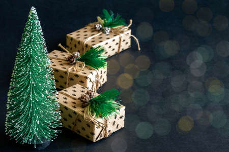 Gift wrapping background. box for a Christmas gift made of paper, decorated with cones and twine.の写真素材