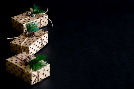 Gift wrapping background. box for a Christmas gift made of paper, decorated with cones and twine.の写真素材