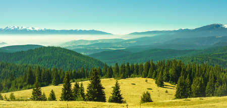 View from the side of Lake Belmeken to the Rila mountains and the peaks of the Pirin mountains in the fogの写真素材