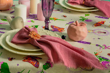 Table setting, white plates with pink napkinsの写真素材