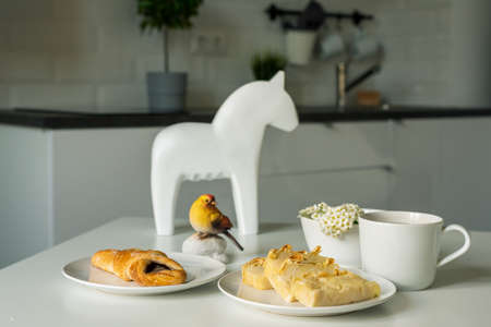 Breakfast - pies and tea in the kitchen in white tones.