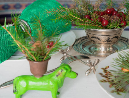 New Years table setting with linen tablecloth, candles and spruce branchesの写真素材
