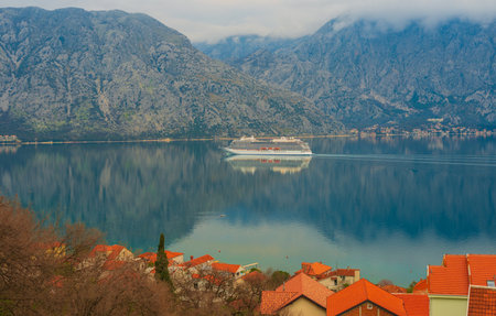 Beautiful mediterranean landscape. Cruise liner near the town of Prcanj, Dobrota in the Bay of Kotor Montenegro.の写真素材