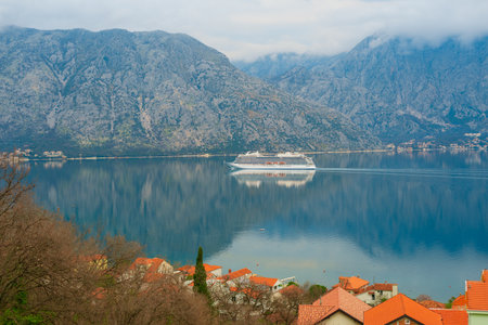 Beautiful mediterranean landscape. Cruise liner near the town of Prcanj, Dobrota in the Bay of Kotor Montenegro.の写真素材