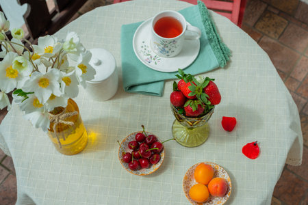 Morning tea with flowers and fruits on the terrace of a country house. Flat layの写真素材