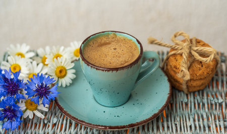 Morning blue cup of coffee, cookies, chamomile and cornflowers. Creative breakfast for Womens Dayの写真素材