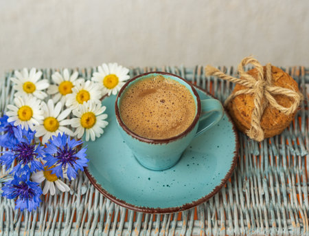 Morning blue cup of coffee, cookies, chamomile and cornflowers.の写真素材