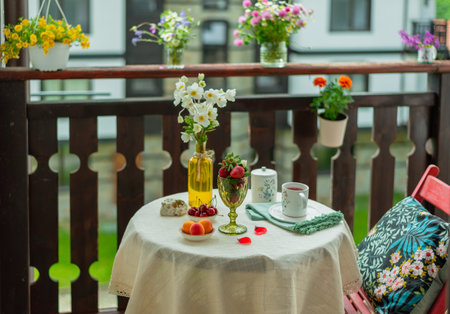Morning tea with flowers and fruits on the terrace of a country house.の写真素材