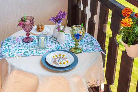 Table on the terrace with soft drinks, flowers and a plate of daisiesの写真素材