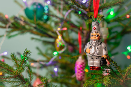 Glass New Year's toy Doctor hangs on a Christmas tree. Wishing you health in the new year.の写真素材