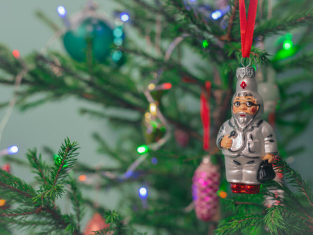 Glass New Year's toy Doctor hangs on a Christmas tree. Wishing you health in the new year.の写真素材