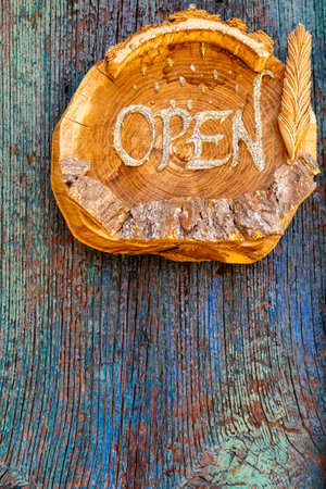 Wooden sign board hanging on door of cafeの写真素材