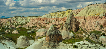 Martian landscape in Cappadocia, unique relief of mountains painted in yellow and pink colorsの写真素材
