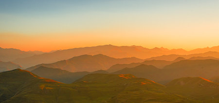 Panoramic mountain landscape in the rays of the setting sun.の写真素材