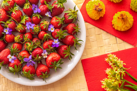 Plate with strawberries, forest spring flowers and cookies.の写真素材