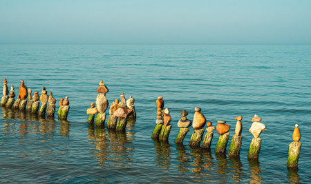 Wooden pillars from a destroyed pier on the Baltic Seaの写真素材