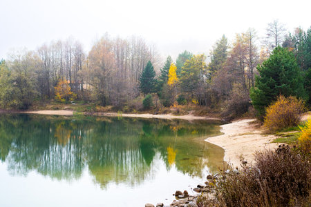Bansko Bulgaria, autumn panorama in the fog water of the lakeの写真素材