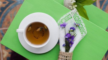 Cup of herbal tea, bouquet of spring flowers in the gardenの写真素材