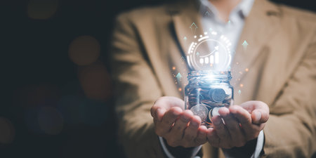 Man holding a jar of money coins and showing money growth concept ,financial concept and saving money , investment savings ,Planning savings for the future ,retirement fund ,future risk managementの写真素材