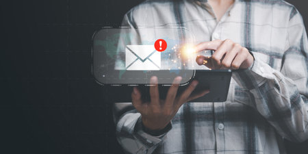 Businessman checking electronic mail notification ,Email marketing and newsletter concept ,Digital communication with email messages ,Sending and receiving messages online with the email iconの写真素材