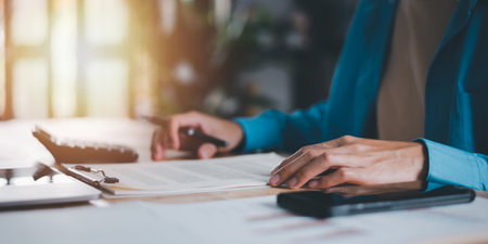 Office worker checking business documents ,accounting documents ,auditor ,management and auditing of office documents ,Reports for Tax Time Analysis ,market data report analysis and consultingの写真素材