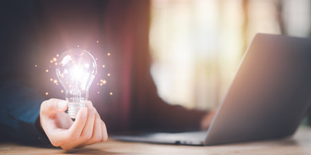 Entrepreneur shows innovative ideas and brain power from brainstorming with light bulbs ,Finding new solutions to solve business problems ,Finding Creativity and Inspiration ,successful business ideasの写真素材