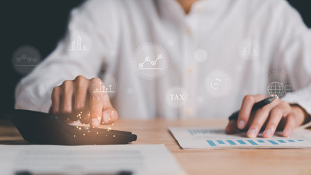 Businessman reading reports, graphs and charts, business statistics ,and use a calculator calculate business growth ,Analysis and improvement of corporate strategy ,Statistics and Data Conceptsの写真素材