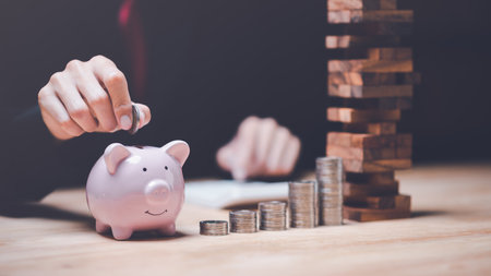 A man put coin money in piggy bank,Financial risk management,Business Investment Feasibility Assessment,protection of business interests,business risk analysis,Decisions on Business Opportunitiesの写真素材
