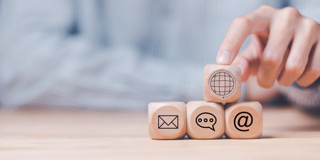 Man pointing at a wooden block,Communication concept with email, message box and contacts icons,Website page contact,Connection with modern network technology,borderless communication ,contact usの写真素材