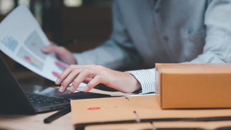 Startup or small business entrepreneur,Check sales and check business growth reports,order management in online stores,shopping on the internet,Selling online on Internet,SME,shipping boxes,e-commerceの写真素材
