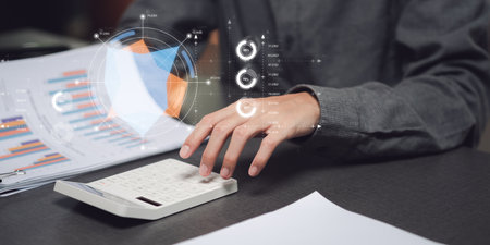 Businessman reading graph report and business statistics charts ,Analysis and improvement of corporate strategy ,Statistics and Data Concepts ,update annual budget accounts ,business growth graphの写真素材