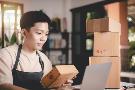 Startup or small business entrepreneur , check the sales from the website,order management in online stores, shopping on the internet,Selling online on the Internet,SME,shipping boxes,e-commerceの写真素材