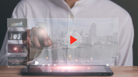 man pointing at virtual icon, to watch videos via wireless technology,Training, learning,...
