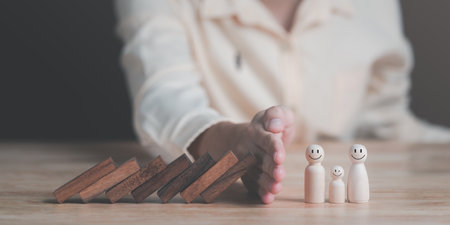 Human hands blocking wooden sticks,Financial risk management and strategic planning through data...