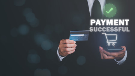 Young businessman using credit card to make financial transactions via smartphone, payment concept with wireless communication technology, focus on consumer safety and cashlessness,successful paymentの写真素材