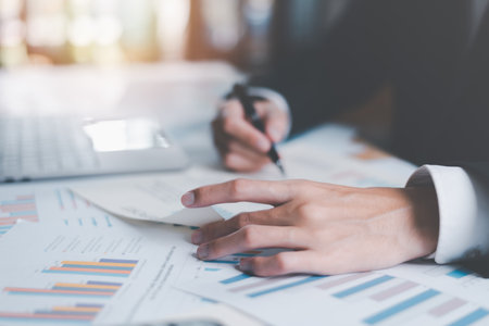 Business people read business statistics chart reports, to analyze and improve corporate strategy, manage financial and marketing documents, update annual budget accounts, company growth data.の写真素材