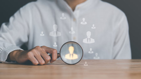 HRM ,Human Resource Management ,Strategic planning for success through people business development concept by choosing professional leaders employee competency Teamwork,man holding a magnifying glassの写真素材