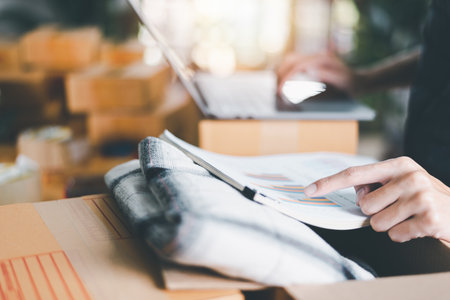 Startup or small business entrepreneur,check business growth report,order management in online stores, shopping on the internet,Selling online on the Internet,SME,shipping boxes,e-commerceの写真素材